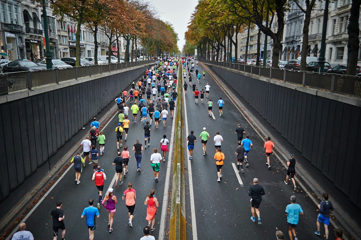 Dusk silhouette photo of runners on a road